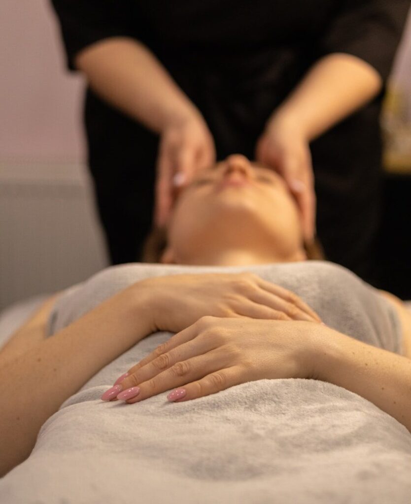 a woman getting a facial massage at a spa